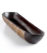 Hand-carved from a branch of the fast-growing obeche tree, this rustic boat bowl is an ode to the Haitian mountainside and designed by Haiti's master woodwork artist, Einstein Albert. A unique vessel for displaying cool objects, fake fruit or simply accenting the table.