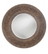 The Hampton mirror's round frame features a striking ring design that mimics a marble mosaic finished with a gorgeous patina. Its eclectic elegance makes it suitable for many contemporary spaces.