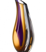 With the extraordinary beauty and grace of an orchid blossom, this Kosta Boda vase adds brilliant artistry to modern interiors. Luxurious art glass handcrafted in a wide, fluid shape glistens with streaks of rich violet and warm amber.