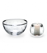 The Larabee Dot votive is the perfect decoration for any tabletop or mantel. Etched polka-dots on clear crystal lend elegance to your home. Votive holder shown front left.
