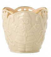 Combining elegant cutwork, gold trim and St. Nick in ivory porcelain, this Merry Lights candle holder shines a light on Christmas.