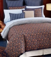 Inspired by classic Tommy Hilfiger style, this Shelburne Paisley duvet cover set features a landscape of printed multicolor paisley designs surrounded by a solid navy frame border. The set reverses to chambray blue with a navy pinstripe pattern. Button closure.
