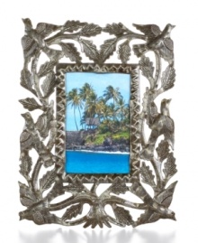 Painstakingly cut, hammered and varnished by hand, this meaningful picture frame displays your favorite people and places in the tree of life. Steel from recycled barrels gives each one-of-a-kind piece a rustic beauty perfected by Haiti's master artisans. Painstakingly cut, hammered and varnished by hand, this meaningful picture frame displays your favorite people and places in the tree of life. Steel from recycled barrels gives each one-of-a-kind piece a rustic beauty perfected by Haiti's master artisans.