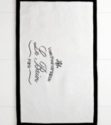 Parisian-inspired elegance transforms the bathroom with this Le Bain rug from Kassatex, featuring a beautiful white cotton ground embellished with French words for a classic and refined look.