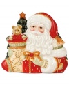 Trim the table, too. The Bountiful Holiday napkin holder from Fitz and Floyd sandwiches napkins between jolly old St. Nicholas and two festively decked trees with extraordinary detail.