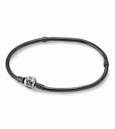 PANDORA's iconic bracelet is dark and dramatic in oxidized sterling silver. A polished signature clasp adds a bright touch.