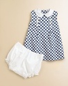 Bold polka dots are fresh and sweet on a simple cotton dress with a gently flared shape.Contrast Peter Pan collarSleevelessCenter front wide pleat with decorative shell buttonsBack button closeSlightly flared shapeSolid bloomers with elasticized waist and leg openingsCotton liningCottonMachine washImported Please note: Number of buttons may vary depending on size ordered. 