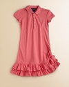 A cotton mesh polo dress teems with ruffles at the hem for a pretty update to a preppy essential.Ribbed polo collarShort capped sleevesButton frontSide ruchingTiered ruffle hem with bow detailCottonMachine washImported Please note: Number of buttons may vary depending on size ordered. 