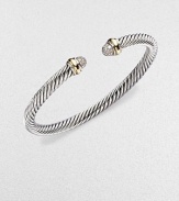 A signature Yurman cable of sterling silver, richly enhanced by bands of 18k yellow gold, encircling pavé diamond domed end caps. Diamonds, 0.30 tcw Sterling silver and 18k yellow gold Cable, 5mm Diameter, about 2½ Made in USA