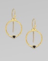 From the Clover Collection. A simple, delicate hoop of 24K gold with a single black diamond accent.Black diamond, 0.24 tcw 24K yellow gold Width, about ¾ Length, about 1 Ear hooks Imported 