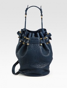Gorgeous pebble-grain leather in a roomy drawstring bucket silhouette finished with antiqued brass hardware and dual strap options.Top handle, 8¼ dropDetachable adjustable crossbody strap, 14½-20¼ dropDrawstring closureOne outside open pocketProtective metal feetOne inside zip pocketTwo inner compartmentsFully lined11½W X 8H X 5DImported