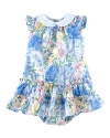 A timeless dress is adorned with sweet floral print and complementing ruffles.