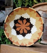 An artist's interpretation of the many peaks and valleys in Rwanda, the handcrafted Umusozi basket will change the landscape of your own home with its rich blend of sienna, gold and mocha tones. Use as a fruit bowl and simply accent the table.