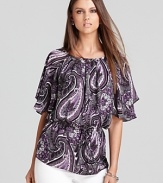 With a nod to the '70s, this MICHAEL Michael Kors top embraces paisley print with a blouson bodice and flutter sleeves. Modernize the retro silhouette with sleek skinny jeans for the ultimate fashion mix.