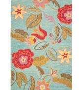 A soothing arrangement. The Blossoms area rug presents ultra-modern florals scattered across a cool blue ground. Woven meticulously in India of soft, long wool fibers, its intricate composition is as attractive as it is durable.