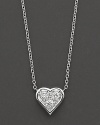 A delicate pendant diamond-encrusted heart necklace in 18 Kt. white gold, with signature ruby accent. Designed by Roberto Coin.