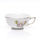 A timeless collection of dinnerware, decorated with whimsical hand-painted butterflies in a modern color palette, delicately scalloped at the edges and accented with gold, brings classic sophistication to the table.