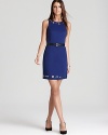 Metal grommets punctuate a sleek MICHAEL Michael Kors sheath dress for classic femininity infused with modern edge.