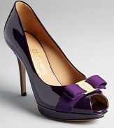 Subtly textured purple patent leather adds sensual allure to Salvatore Ferragamo's peep toe platform pumps.