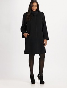 A streamlined silhouette with a mandarin collar. Mandarin collar with button detail Long sleeves Concealed front button closure Slash pockets About 35½ from shoulder to hem Fully lined 60% wool/20% angora/20% nylon Dry clean Made in Italy 