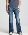 The Zathan jean features a regular fit bootcut silhouette accented with whiskering and fading details, plus signature Diesel stitching on the back pockets.