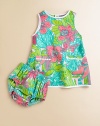 Lush and lovely tropical flowers on crisp cotton with contrast trim and embroidery.Round necklineSleevelessSlightly flared shapePatch pockets with embroideryBack buttons with curved contour hemMatching bloomer with elasticized waist and leg openingsFully linedCottonMachine washImported Please note: Number of buttons may vary depending on size ordered. 
