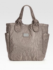 Signature letter stitching is at the center of this roomy carryall, complete with a logo metal plaque and delicately-knotted top handles. Double top handles, 7 dropMagnetic snap closureTwo outside open pocketsOne inside zip pocketTwo inside open pocketsLogo-printed canvas lining13W X 14¾H X 4½DImported