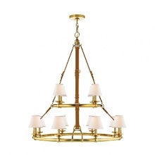 Elegantly rendered in luxurious saddle leather and brass, this modern Ralph Lauren chandelier illuminates through twelve bulbs topped with textural linen shades.