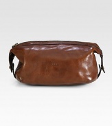 An impeccably stylish carrying case for the modern gentleman, this lightweight pouch in a leather construction provides sharp transport for essential toiletries.Zip closureAntiqued brass hardwareEmbossed logo accents at the exteriorLeather9W x 5HImported