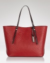 Complete a classic look with this embossed leather tote from Michael Kors. A simple yet spacious design and subtle textured detailing make this understated classic an ever-chic piece.