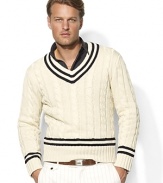 Fashioned in a heritage cable knit from luxe Italian cotton, a classic V-neck sweater is adorned with cricket stripes and herringbone wool elbow patches for authentic style.