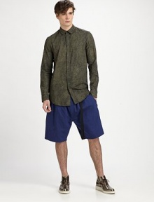 A subtle texture and a pattern that evokes granite or marble this woven design with just enough edginess. Modified point collarHidden front buttonsLong sleeves with barrel cuffsExtended back shirttail hemCottonDry cleanImported