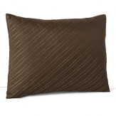 Glinting threads of copper stitched on a diagonal adorn this earthy decorative pillow from Calvin Klein Home.