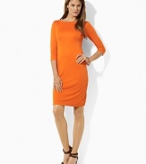 A mod jersey shift dress is crafted with a boat neckline and three quarter sleeves for a sleek look.