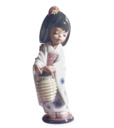 Wearing a traditional Japanese kimono and pretty hair comb, this little girl is ready for her biggest dance performance yet. Handcrafted in Lladro porcelain.