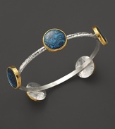 A bold sterling silver bangle from Gurhan with Paua shell stations in 24K yellow gold.