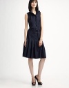 A pleated skirt, button front detail and sporty belt add edge to this classic shirtdress design.Band collarButton frontAdjustable D-ring self beltDrop waistPleated skirtFully linedAbout 24 from natural waistCottonDry cleanImported of Swiss fabricModel shown is 5'9 (175cm) wearing US size 4. 