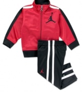 On or off the court, he'll look and feel like a pro superstar in this Jordan track suit by Nike Kids.