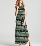 In soft, printed jersey, Ali Ro's maxi dress is sleek in a tiled print. A belted waist lends a flattering fit.