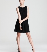 A sleek city basic, this DKNY dress gains feminine flair with delicate pleats and sheer styling. Sky-high pumps inject the style with provocative edge.