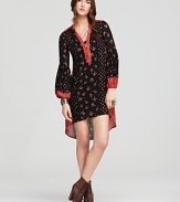 This Free People dress plays up the season's hippie mood, flaunting florals on a loose-fitting silhouette designed with bell sleeves and a of-the-moment high/low hem.