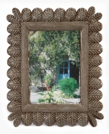 Get nesting. Hand cut and hammered in recycled steel by artist Rony Jacques, this rustic picture frame displays your favorite people and places between rows of beautiful songbird feathers. Once the hammered detail is complete, each is varnished and dried in the hot Caribbean sun. Get nesting. Hand cut and hammered in recycled steel by artist Rony Jacques, this rustic picture frame displays your favorite people and places between rows of beautiful songbird feathers. Once the hammered detail is complete, each is varnished and dried in the hot Caribbean sun.