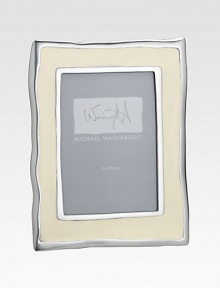From the Como Collection. Inspired by the gentle ripples and soft hues of Italy's Lake Como, this enamel frame has wavy edges that add rich character to a favorite photo.Enamel over aluminumRed leather backHolds a 5 X 7 photoMade in USA From the Como Collection. Inspired by the gentle ripples and soft hues of Italy's Lake Como, this enamel frame has wavy edges that add rich character to a favorite photo.Enamel over aluminumRed leather backHolds a 5 X 7 photoMade in USA