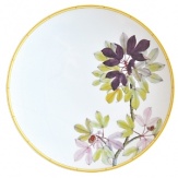 Adapted from botanical drawings of gardens in Mumbai, India, where an abundance of rare plant species grow, precisely detailed floral and vegetal illustrations adorn this fine porcelain plate from Bernardaud. It's edged with a rattan trompe l'oeil pattern reminiscent of popular Indian furniture designs.