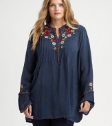 Featuring classic pleats and lively embroidery, a must-wear tunic. Try wearing this top with slim-fitting pants or leggings.Round neckLong sleevesButton placketEmbroidered detailsAbout 32 from shoulder to hemRayonMachine washImported