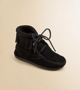 A traditional moccasin gets a cute and stylish update in a high-top design with 70's-inspired fringe and front tie.Tie closureSuede upperRubber solePadded insoleImported