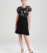 Blooming with dark florals, this DKNY dress lends dark romance to your 9-to-5 repertoire. Toughen up the delicate silhouette with a structured leather jacket for the perfect style mix.