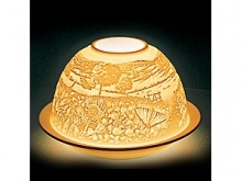 In the world of French art de vivre, Bernardaud is considered the symbol of elite refinement and luxury. A porcelain creation signed by Bernardaud is always appreciated and recognized the world over. Bernardaud artisans use the same technique of hand-sculpting fine, bisque porcelain that was first demonstrated by French artist Paul de Bourgoing in 1828. The glow of a candle shines through the raised and carved surface to contrast light against shadow, revealing a richly detailed design. Bernardaud VotiveLight™ candles add a warm, decorative glow to any room of the home. For a dramatic effect, or to create a festive ambiance, delight your dinner guests by replacing traditional candles with a Bernardaud VotiveLight™.