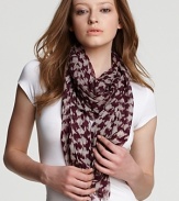 Purple and white houndstooth with BRIT logo decorate this sheer wool scarf from Burberry.