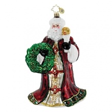 A regally dressed Santa holds a torch and festive wreath.